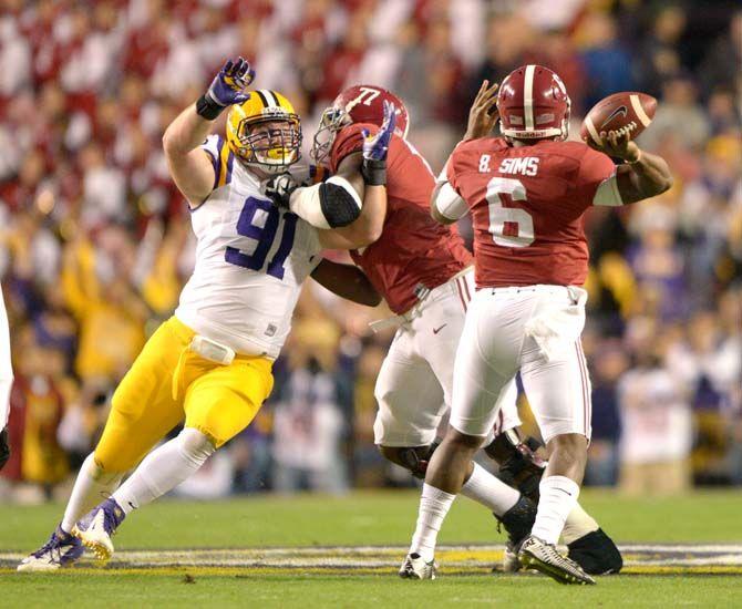 LSU sophomore defensive tackle Christian LaCouture (91) lunges for Alabama senior quarterback Blake Sims (6) Saturday, Nov. 8, 2014 during the Tigers' 20-13 loss against the Crimson Tide in Tiger Stadium.