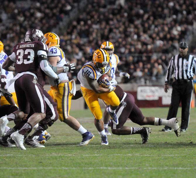 LSU senior running back, Terrence Magee (18), runs the ball down Kyle Field, College Station on November 27 where Tigers had a 23-17 victory against Texas A&amp;M.