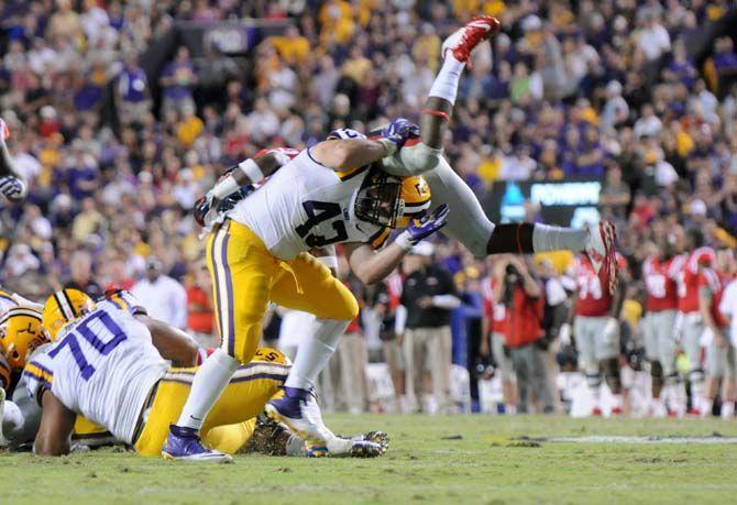 LSU senior fullback, Connor Neighbors (43), tackles Ole Miss junior defensive back, Trae Elston (7) in Tiger Stadium Saturday, October 25, 2014 where LSU won 10-7.