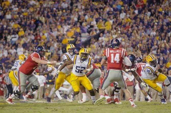 LSU sophomore linebacker Kendell Beckwith (52) runs to tackle Ole Miss quarterback Bo Wallace (14) during Tigers' 10-7 victory Saturday, October 25, 2014 in the Tiger Stadium.