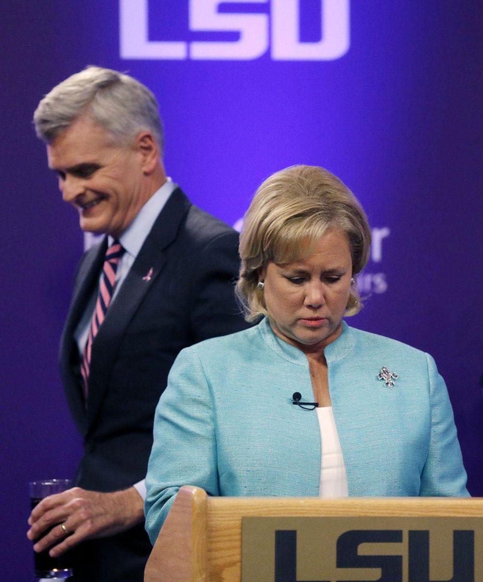 Sen. Mary Landrieu, D-La., and Rep. Bill Cassidy, R-La., take their places to participate in a Senate race debate with and Republican candidate and Tea Party favorite Rob Maness on the LSU campus in Baton Rouge, La., Wednesday, Oct. 29, 2014. (AP Photo/Gerald Herbert)