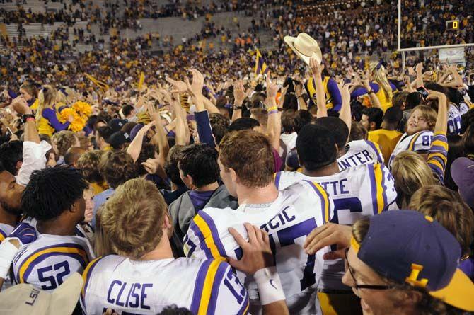 Lsu football players and students rush the field and celebrate the Tigers' 10-7 victory against Ole Miss Saturday, October 25, 2014 in LSU Tiger Stadium.