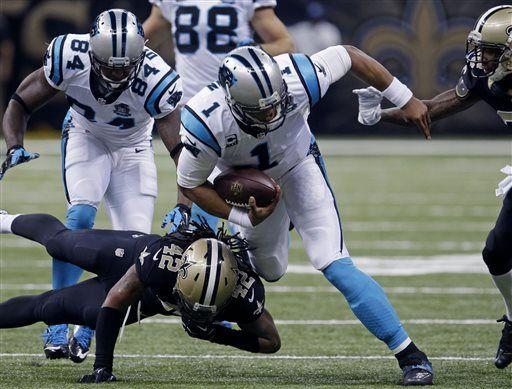 Carolina Panthers quarterback Cam Newton (1) is tackled by New Orleans Saints defensive back Pierre Warren (42) in the first half of an NFL football game in New Orleans, Sunday, Dec. 7, 2014. (AP Photo/Bill Feig)