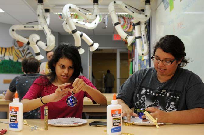 LSU mass communication and french language senior Ana Arjueta and women and gender studies senrio Alexandria Andara decorate an ornament in the Leisure Arts studio in the Union Friday, Dec. 5, 2014 for "Deck the Union Halls."