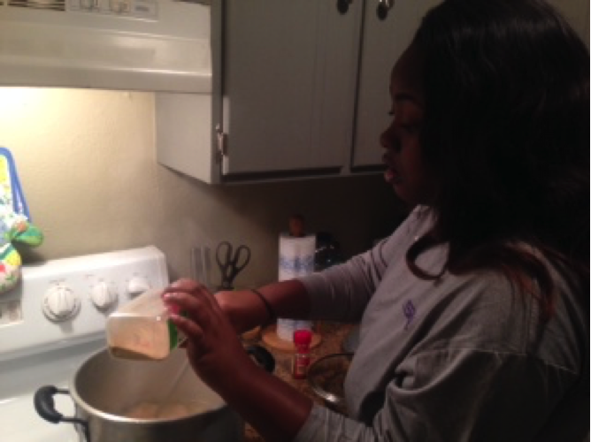 Willona McNeal, an Alexandria native, seasons her gumbo to give it an extra kick.