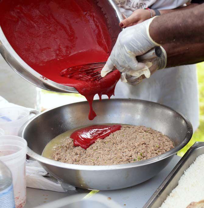 Salted blood is whisked into boudin stuffing Sunday, November 30, 2014 at La Boucherie Merci in Vermillionville, La.