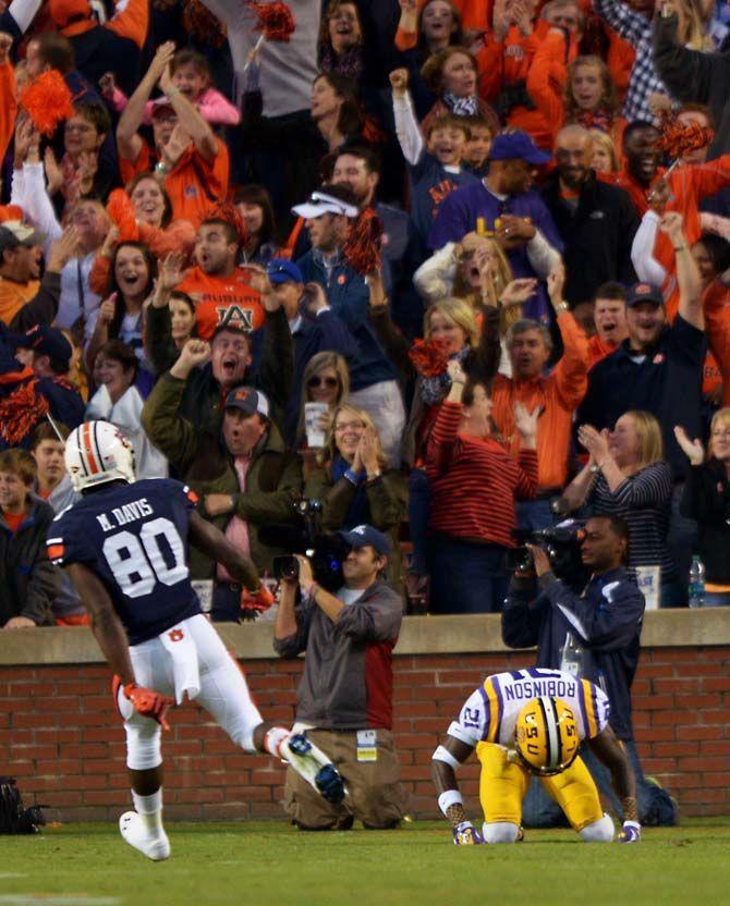 LSU sophomore defensive back Rashard Robinson punches the ground as Auburn sophomore wide receiver Marcus Davis (80) and the crowd celebrate a touchdown Saturday, October 4, 2014 during the LSU Tigers' 41-7 loss against the Auburn Tigers in Jordan-Hare Stadium.