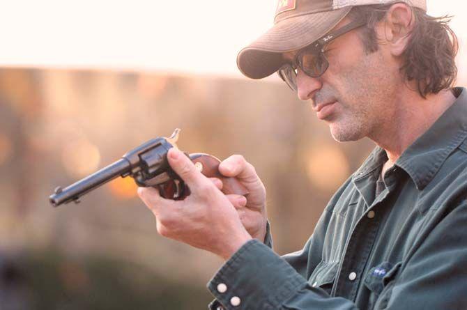 Toby Rodriguez inspects his revolver Sunday, November 30, 2014 at La Boucherie Merci in Vermillionville, La.