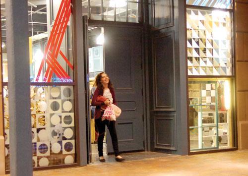 Alex Laney, art history senior, walks out of the Urban Outfitters in Perkins Rowe with bags in hand on Monday evening.