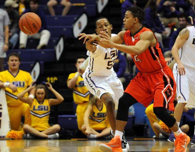 LSU sophomore guard Tim Quarterman (55) and Sam Houston State junior guard Paul Baxter (21) both attempt to gain posession of the ball Saturday, Dec. 13, 2014 during the Tigers' 76-67 win against the Bearkats in the PMAC.