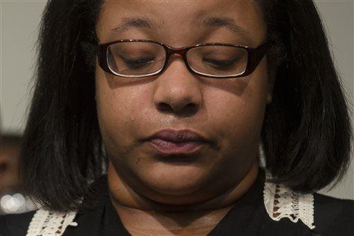 Emerald Garner, daughter of Eric Garner, cries during a news conference at the National Action Network headquarters in New York on Wednesday, Dec. 3, 2014 after a grand jury's decision not to indict a New York police officer involved in the death of Eric Garner. A video shot by an onlooker and widely viewed on the Internet showed the 43-year-old Garner telling a group of police officers to leave him alone as they tried to arrest him. The city medical examiner ruled Garner's death a homicide and found that a chokehold contributed to it. (AP Photo/John Minchillo)