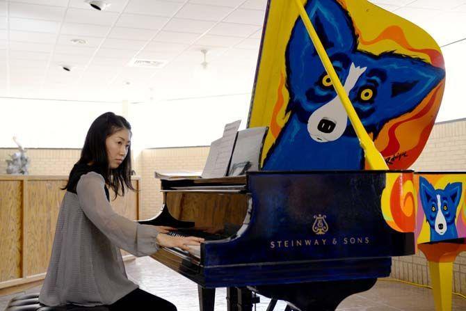 LSU student plays an original vintage Steinway piano painted by George Rodrigue Monday, Dec. 1, 2014 in the LSU School of Music lobby. The George Rodrigue Foundation of the Arts donated this artwork to LSU School of Music.