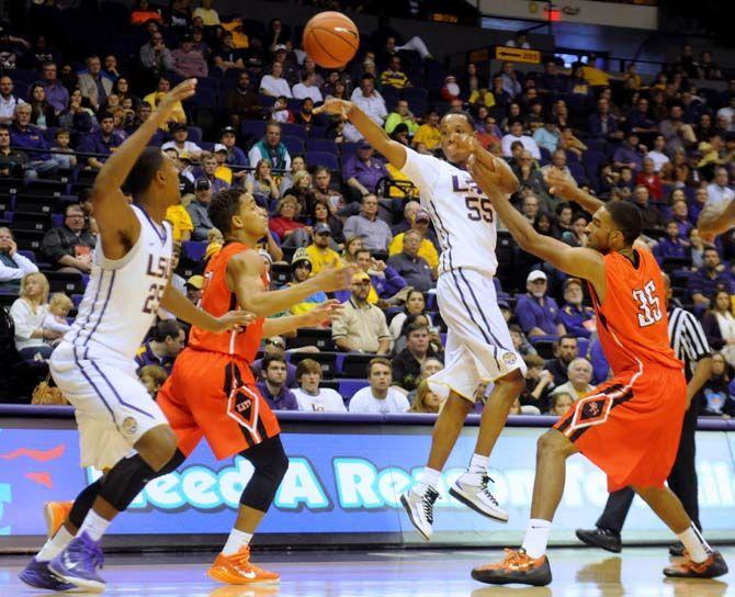 LSU sophomore guard Tim Quarterman (55) passes the ball to sophomore forward Jordan Mickey (25) Saturday, Dec. 13, 2014 during the Tigers' 76-67 win against the Bearkats in the PMAC.