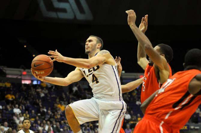 LSU junior guard Keith Hornsby (4) breaks away from Sam Houston State senior center Michael Holyfield (35) and junior guard Paul Baxter (21) Saturday, Dec. 13, 2014 during the Tigers' 76-67 win against the Bearkats in the PMAC.