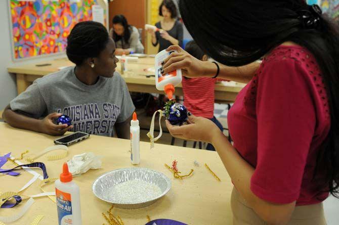 LSU mass communication and french language senior Ana Arjueta decorates an ornament in the Leisure Arts studio in the Union Friday, Dec. 5, 2014 for "Deck the Union Halls."