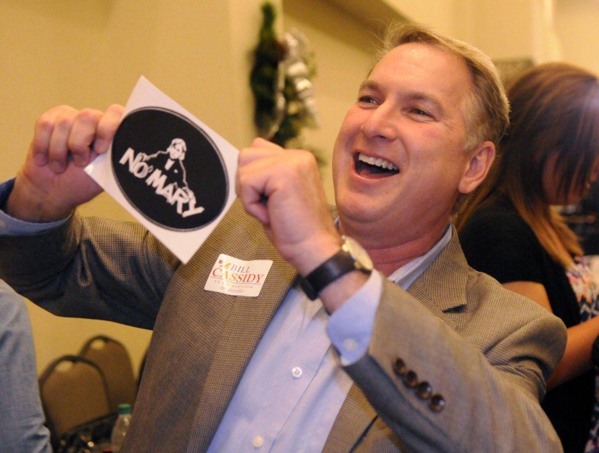 Cassidy supporter Covington councilman Larry Rolling holds up "no Mary" sign at the Crowne Plaza Hotel atrium Saturday December 6, 2014.