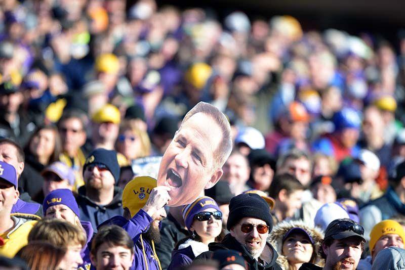 LSU fan holds a poster of Les Miles' face in the crowd at the Music City Bowl Tuesday, Dec. 30, 2014 at LP Field in Nashville.