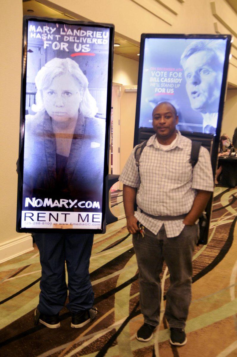Fredrick Sargent and Brother Adrian display signs in the Crowne Plaza Hotel Atrium Saturday December 6, 2014.