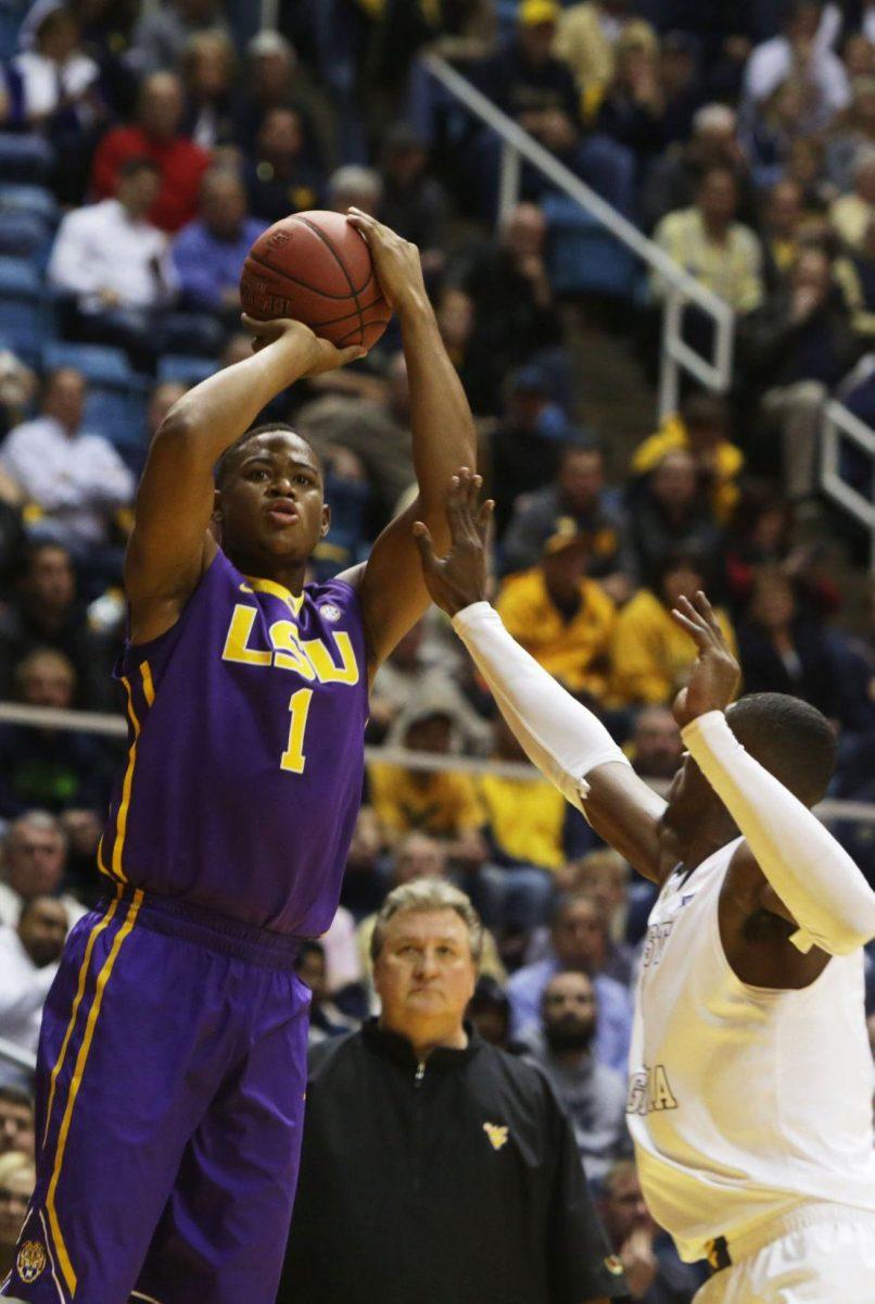 LSU forward Jarell Martin (1) shoots over West Virginia forward Jonathan Holton (1) during an NCAA college basketball game, Thursday, Dec. 4, 2014, in Morgantown, W.Va. (AP Photo/Raymond Thompson)