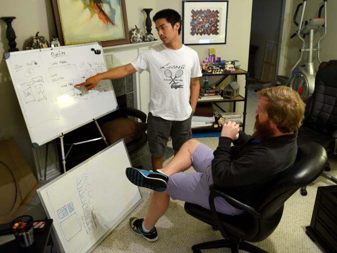 Sparehanger lead web developer Bee Vo explains a new concept for the website to CEO Peter Hubbs.