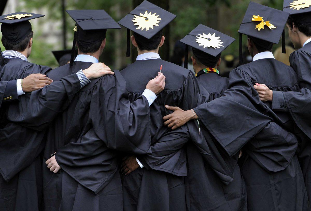 FILE - In this May 20, 2013 file photo, graduates pose for photographs during commencement at Yale University in New Haven, Conn. The job market for new college graduates is brightening but remains weaker than before the Great Recession began. (AP Photo/Jessica Hill, File)