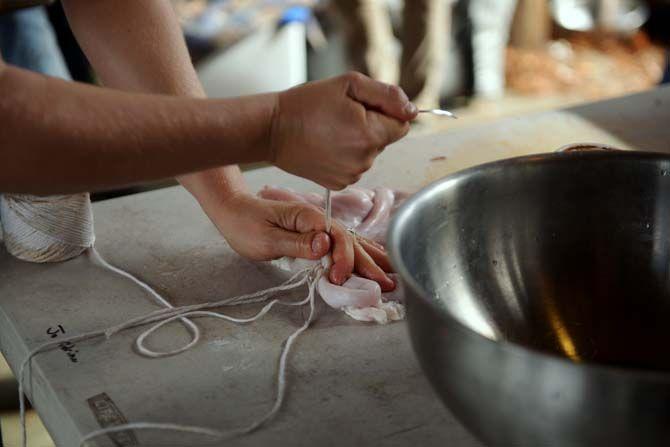 A pig's stomach is sewn closed before being stuffed Sunday, November 30, 2014 at La Boucherie Merci in Vermillionville, La.