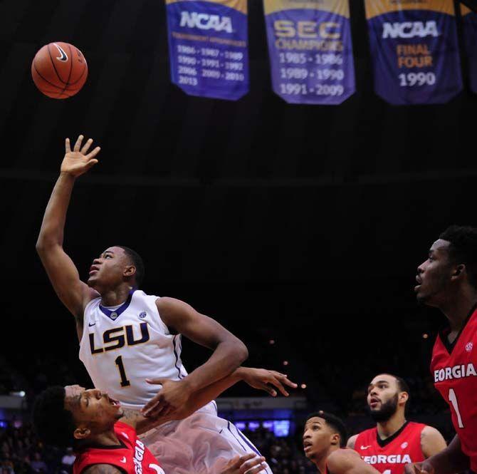 LSU sophomore forward Jarell Martin (1) reaches for the rebound and knocks over Georgia junior guard Charles Mann (4) on Saturday, Jan. 10, 2015, during the Tigers' 87-84 win against the Bulldogs in the Pete Maravich Assembly Center.