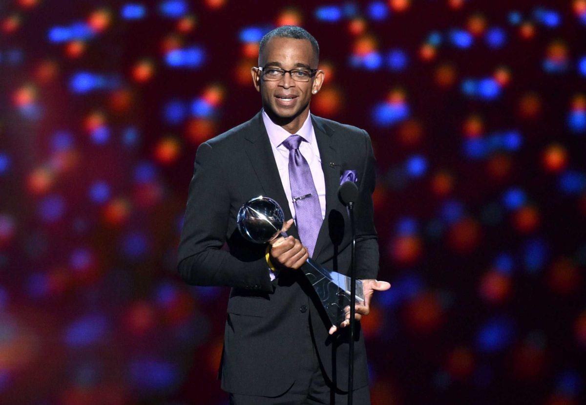 FILE - In a July 16, 2014 file photo, sportscaster Stuart Scott accepts the Jimmy V award for perseverance, at the ESPY Awards at the Nokia Theatre, in Los Angeles. Scott, the longtime &#8220;SportsCenter&#8221; anchor and ESPN personality known for his known for his enthusiasm and ubiquity, died Sunday, Jan. 4, 2015 after a long fight with cancer. He was 49. (Photo by John Shearer/Invision/AP, File)