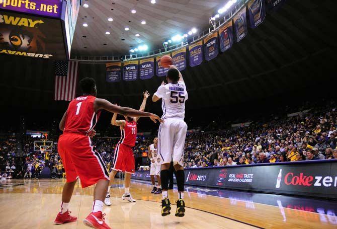 LSU sophomore guard Tim Quarterman (55) passes the ball to freshman guard Jalyn Patterson (15) as Georgia junior forward Cameron Forte (11) attempts to block on Saturday, Jan. 10, 2015, during the Tigers' 87-84 win against the Bulldogs in the Pete Maravich Assembly Center.