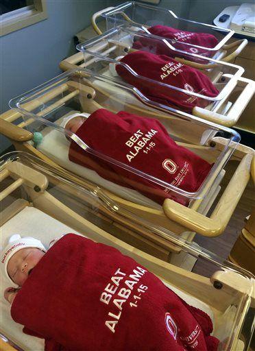 This recent photo provided by The Ohio State University Wexner Medical Center shows babies lying at the hospital in Columbus, Ohio. Every baby born New Year's Day at OSU&#8217;s Wexner Medical Center will be swaddled in a red blanket emblazoned with: &#8220;Beat Alabama. 1-1-15.&#8221; The Buckeyes, of course, play Alabama on Thursday night in the Sugar Bowl in New Orleans in the first college football playoff, with the winner going to the national championship game. (AP Photo/The Ohio State University Wexner Medical Center)