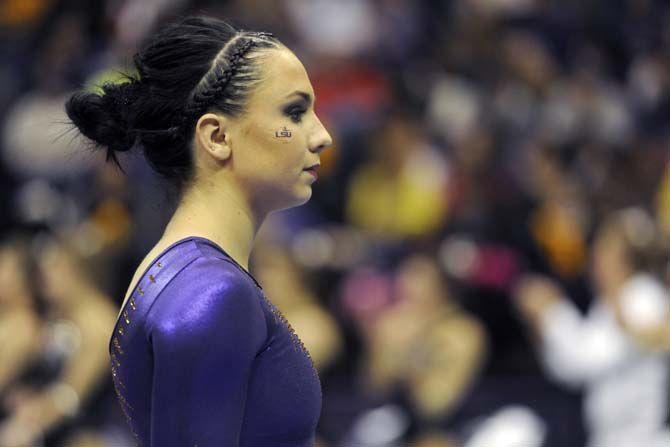 LSU senior Rheagan Courville prepares for her bar routine on Friday, Jan. 9, 2015, during the Lady Tiger's 197-193 victory against Iowa in the PMAC