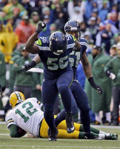 Seattle Seahawks' Cliff Avril (56) celebrates after sacking Green Bay Packers' Aaron Rodgers (12) during the second half of the NFL football NFC Championship game Sunday, Jan. 18, 2015, in Seattle. (AP Photo/Jeff Chiu)