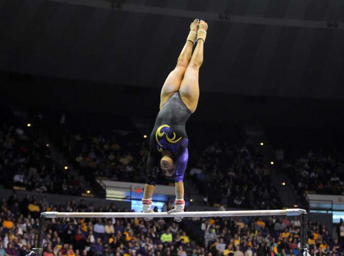 LSU sophomore all-around gymnast Jessica Savona swings around the bars Friday, Jan. 31, 2014 during the Tigers' 197.650-196.825 victory against Alabama at the PMAC.