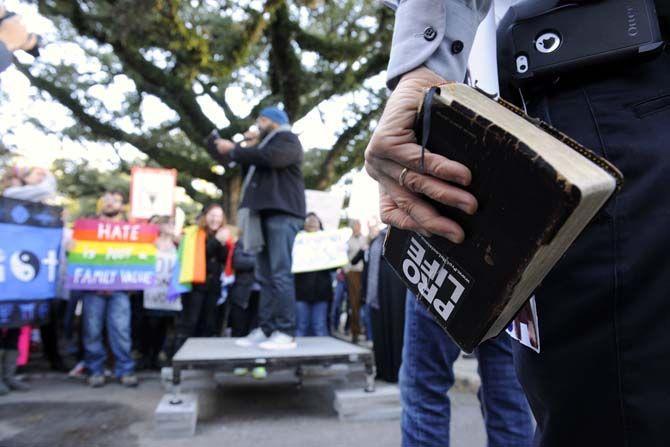 A man stands outside of the Pete Maravich Assembly Center Saturday, Jan. 24, 2015 opposing an organized protest that was held against Bobby Jindal's "The Response."