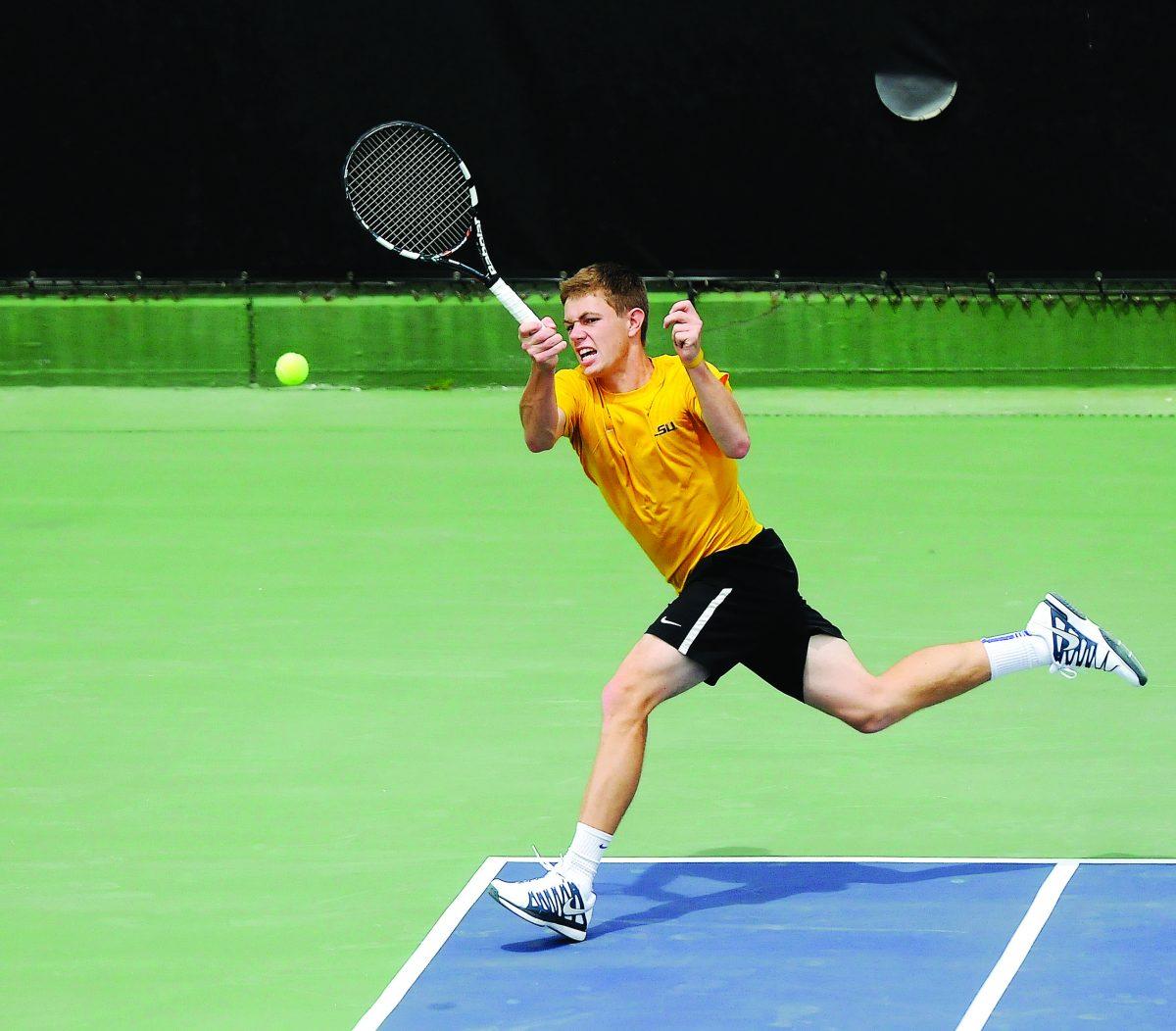 LSU junior Chris Simpson returns a volley Sunday, March 30, 2014 during the Men's Tennis doubles match against Florida at W.T. "Dub" Robinson Stadium.