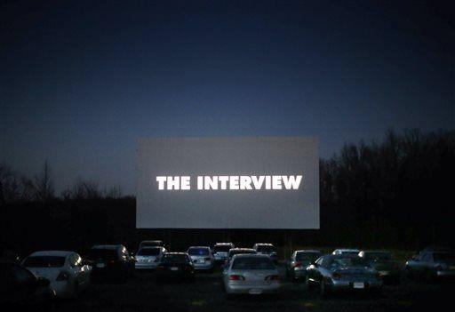 Opening credits roll for "The Interview" at the Goochland Drive-In movie theater Wednesday, Dec. 31, 2014, in Hadensville, Va. (AP Photo/Richmond Times-Dispatch, Dean Hoffmeyer)