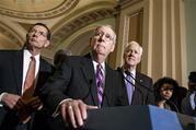 Senate Majority Leader Mitch McConnell of Ky., with Senate Minority Whip John Cornyn of Texas, right, and Sen. John Barrasso, R-Wyo., left, talks with reporters on Capitol Hill in Washington, Wednesday, Jan. 7, 2015, following their first GOP policy meeting since Congress reconvened yesterday. With Congress under full GOP control for the first time in eight years, Republicans are pursuing an ambitious agenda including early votes on bills to advance the long-stalled Keystone XL pipeline and change the definition of full-time work under Obama's health law from 30 hours a week to 40 hours a week. President Obama has threatened to veto both measures. (AP Photo/J. Scott Applewhite)