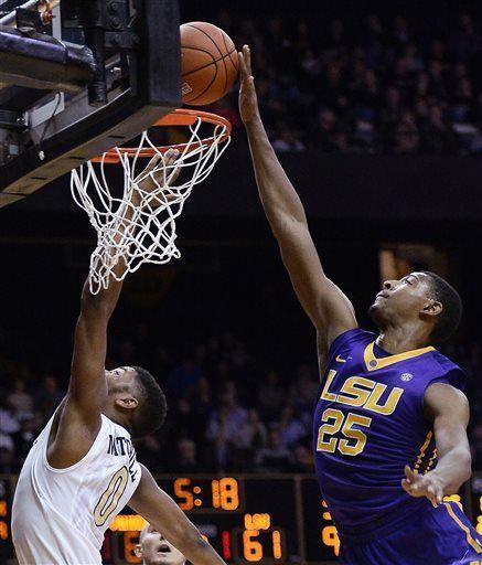 Vanderbilt guard Shelton Mitchell (0) has his shot blocked by LSU forward Jordan Mickey (25) during the second half of an NCAA college basketball game Saturday, Jan. 24, 2015, in Nashville, Tenn. LSU won in overtime 79-75. (AP Photo/Mark Zaleski)