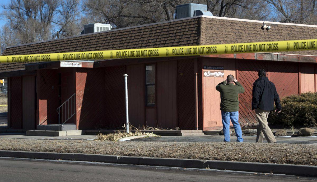 Colorado Springs police officers investigate the scene of an explosion Tuesday, Jan. 6, 2015, at a building in Colorado Springs, Colo. Authorities are investigating whether a homemade explosive set off outside the building that houses a barber shop and the Colorado Springs chapter of the NAACP was aimed at the nation's oldest civil rights organization. (AP Photo/The Colorado Springs Gazette, Christian Murdock ) MAGS OUT