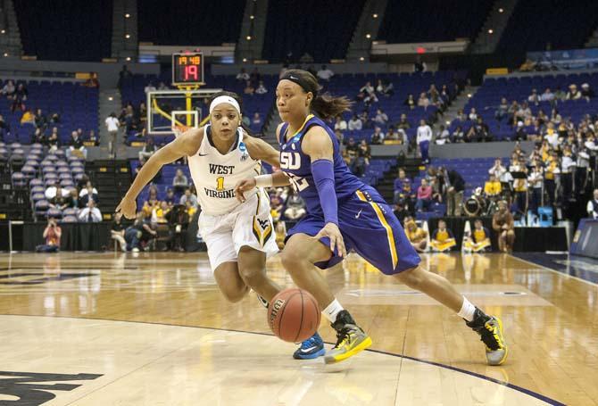 LSU sophomore guard Danielle Ballard (32) dribbles past a West Virginia defender Tuesday, March 25, 2014, during the Tigers' 76-67 win against the Mountaineers in the PMAC.