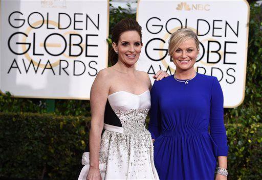 Tina Fey, left, and Amy Poehler arrive at the 72nd annual Golden Globe Awards at the Beverly Hilton Hotel on Sunday, Jan. 11, 2015, in Beverly Hills, Calif. (Photo by Jordan Strauss/Invision/AP)