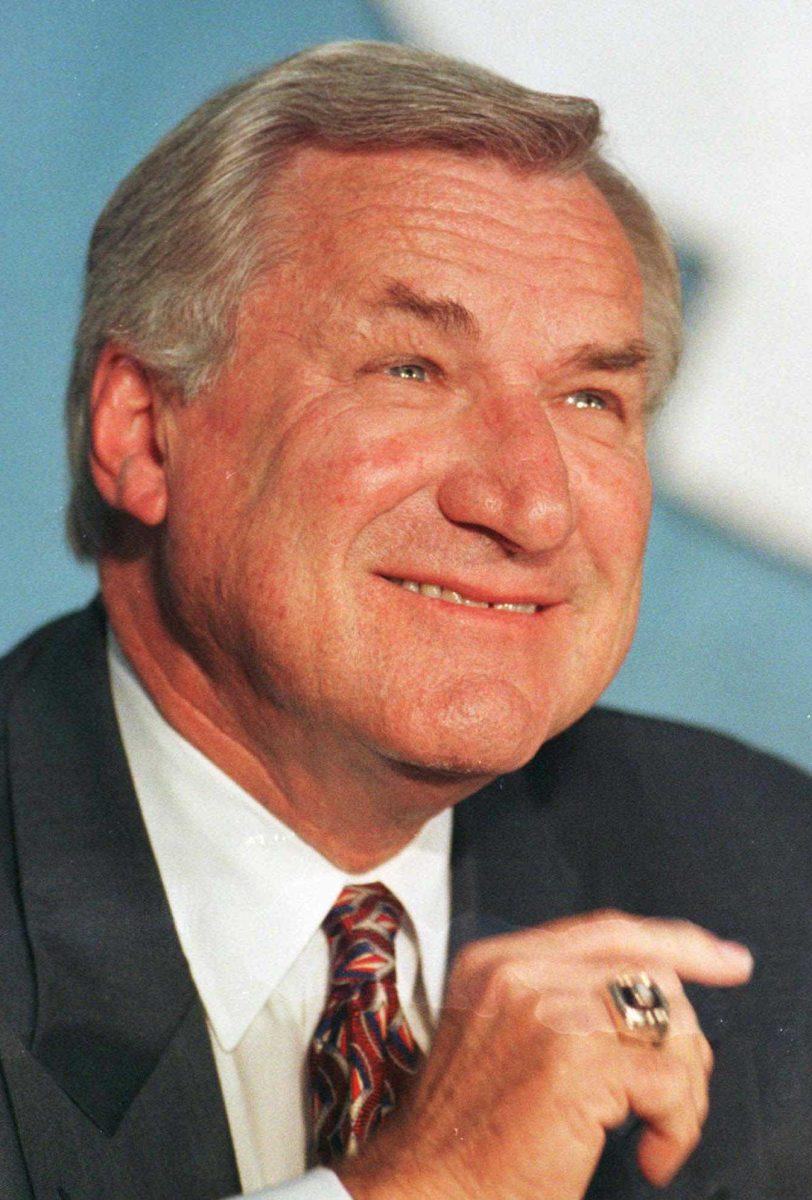 FILE - In an Oct. 9, 1997 file photo, North Carolina basketball coach Dean Smith smiles during a news conference in Chapel Hill, N.C.,where he announced his retirement. Smith, the North Carolina basketball coaching great who won two national championships, died "peacefully" at his home Saturday night, Feb. 7, 2015, the school said in a statement Sunday from Smith's family. He was 83. (AP Photo/Bob Jordan, File)