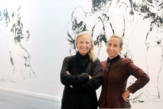 From left, Dr. Laura Larsen and Lucy Perera pose Saturday, Jan. 31, 2015, in the LeRoy Neiman exhibit at LSU Museum of Art.