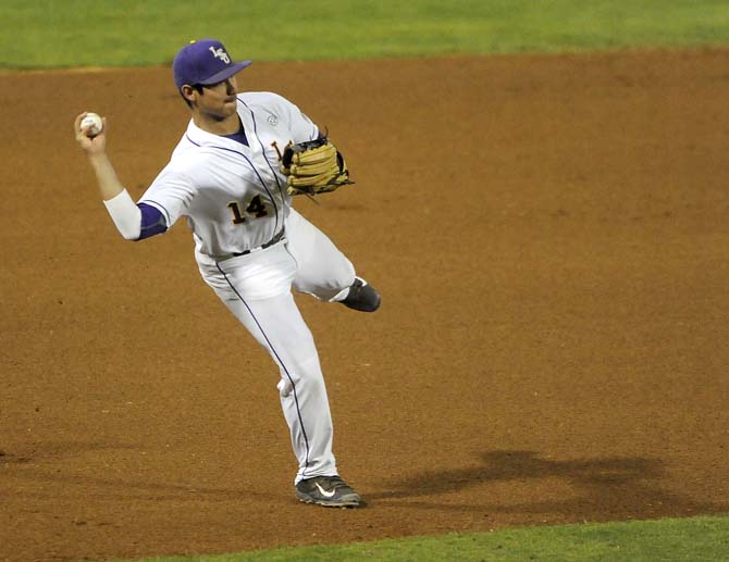 LSU senior infielder Christian Ibarra (14) throws to first Friday, March 7, 2014 during the Tigers' 10-0 victory against Purdue at Alex Box Stadium.