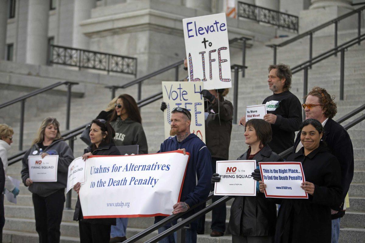 A group opposed to capital punishment plans over one lawmaker's plan to resurrect the use of firing squads protests outside the Utah State Capitol Tuesday, Jan. 27, 2015, in Salt Lake City. The group Utahns for Alternatives to the Death Penalty argues firing squad executions are a gruesome relic of the state's Wild West past that create a media frenzy around condemned inmates. (AP Photo/Rick Bowmer)