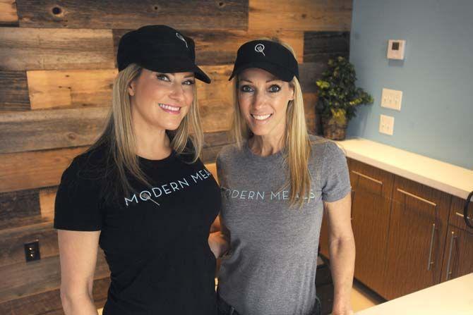 Modern Meals owners Ashley Munnerlyn and Marcy David stand in front of the counter during the soft oppening of the store on Saturday, Feb. 21, 2015. The store offers pre-packaged meals for purchase and it is also a restuarant.