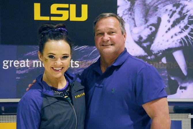 LSU sophomore all- around gymnast, Ashleigh Gnat, with her dad after the Tigers' 197.950 to 197.425 victory against Florida on Friday, Feb. 20, 2015.