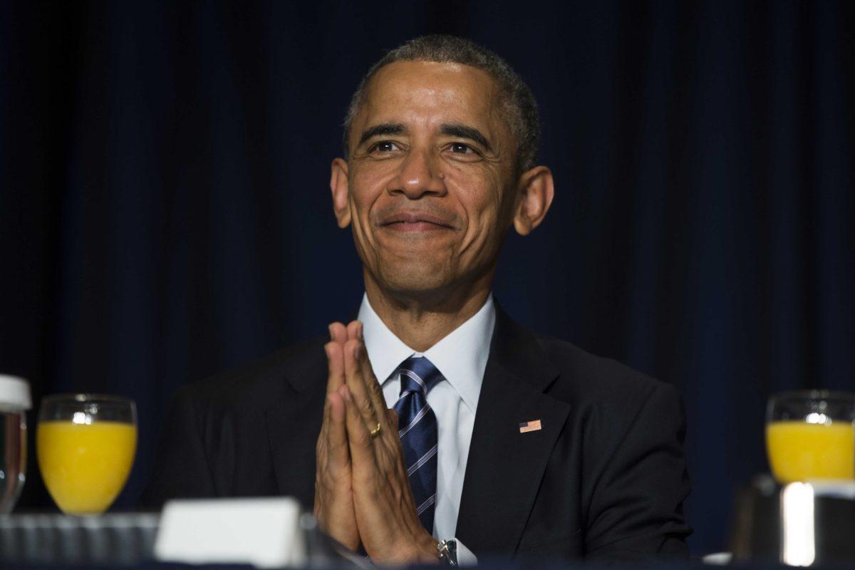 President Barack Obama bows his head towards the Dalai Lama as he was recognized during the National Prayer Breakfast in Washington, Thursday, Feb. 5, 2015. The annual event brings together U.S. and international leaders from different parties and religions for an hour devoted to faith. (AP Photo/Evan Vucci)