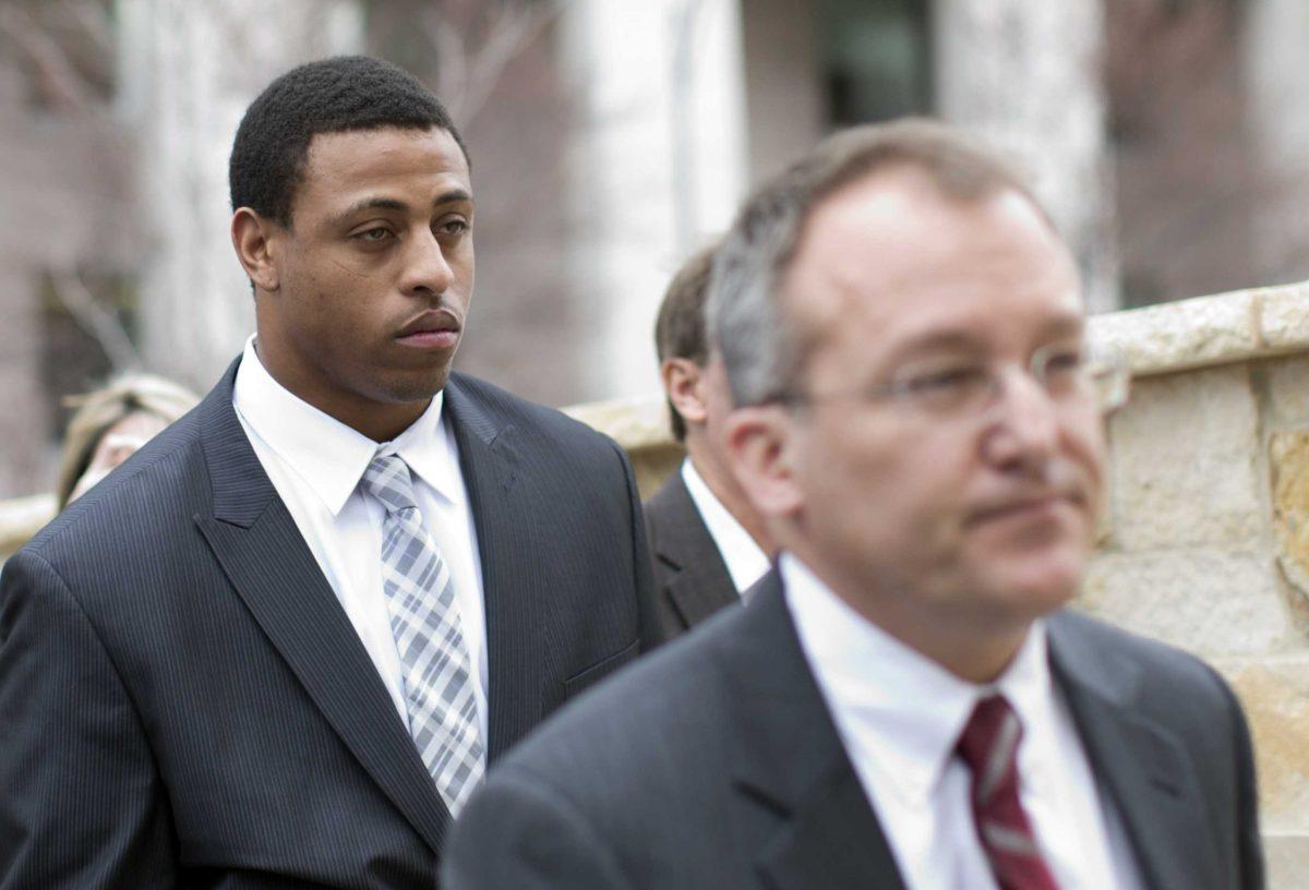 Carolina Panthers' Greg Hardy, left, leaves the Mecklenburg County Courthouse after his domestic violence charges were dismissed in Charlotte, N.C., Monday, Feb. 9, 2015. (AP Photo/Chris Keane)