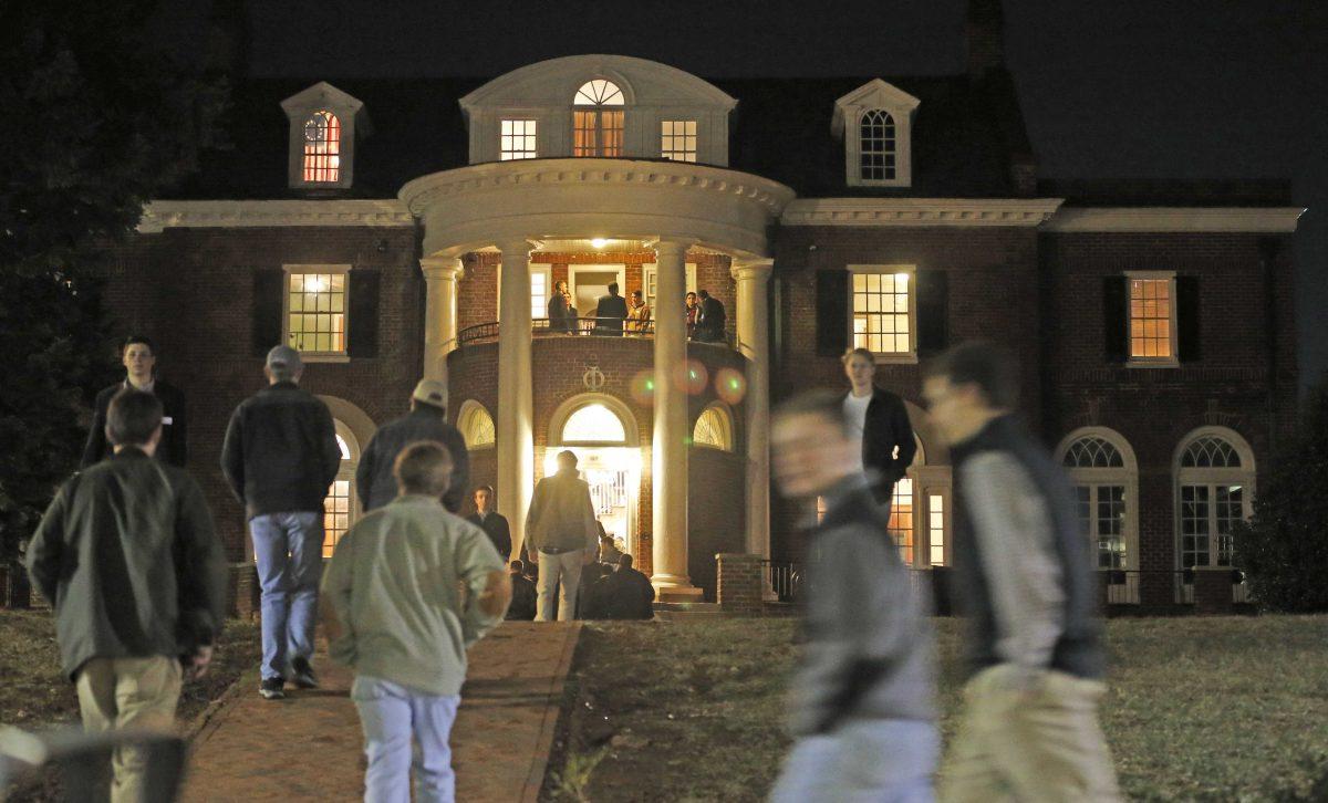 In this Thursday, Jan. 15, 2015 photo, University of Virginia students walk to fraternities at the start of rush week at the University of Virginia in Charlottesville, Va. Two fraternities that threatened to defy the University of Virginia's efforts to impose new regulations governing their parties say they will sign the agreement after all. (AP Photo/Steve Helber)